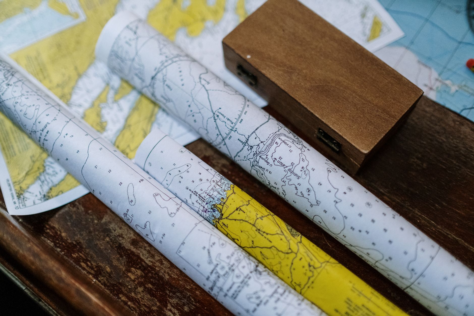 Rolled maps on a wooden table